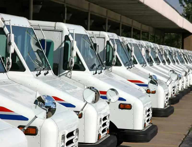 Postal service trucks in a row