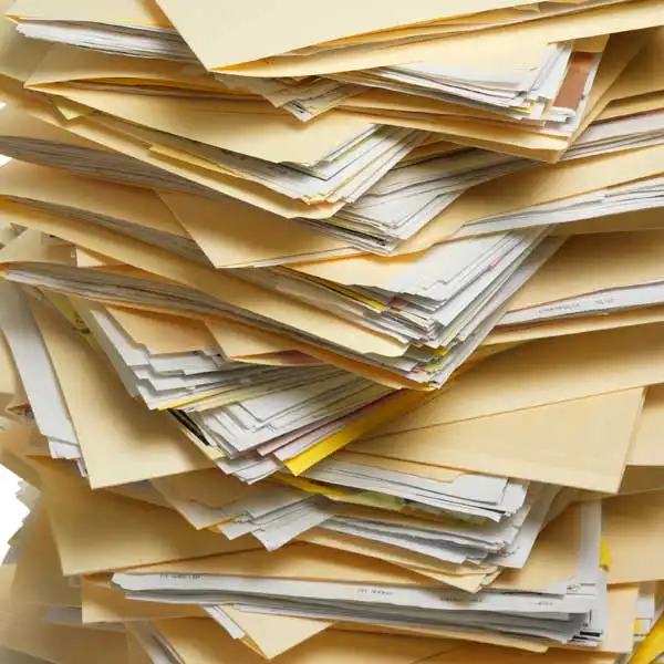 stack of file folders filled with documents