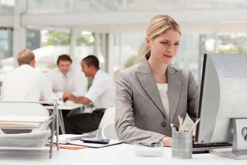 Woman at a computer looking at Document Management software